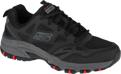 A single black Skechers Hillcrest sneaker is shown from a side angle against a white background.