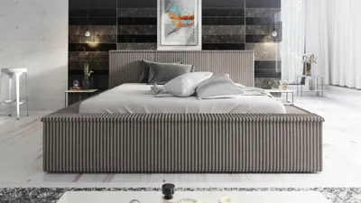 A modern bedroom with a large bed, artwork on the wall, and minimalist furniture.