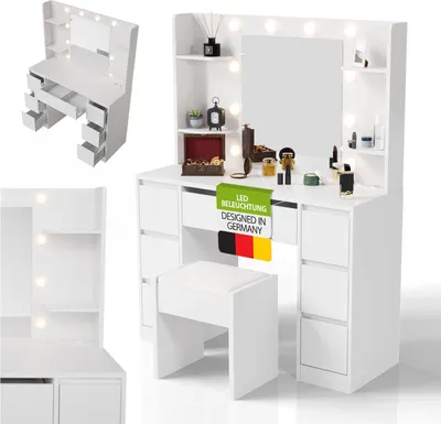 A white vanity table with a mirror and LED lights, along with a matching stool, displayed in a studio setting.