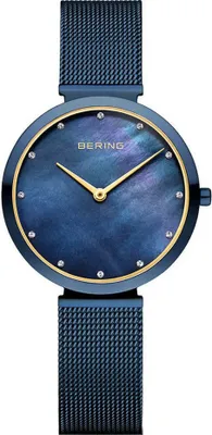 A close-up studio shot of a blue Bering watch with a gold bezel and a mother-of-pearl dial.