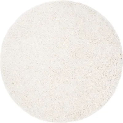 A round, cream-colored rug is shown from a top-down perspective on a white background.
