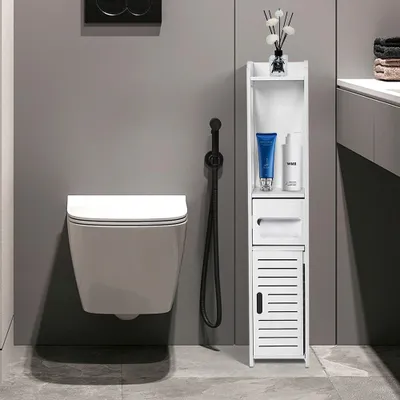 A modern bathroom scene featuring a wall-mounted toilet and a narrow white storage cabinet.