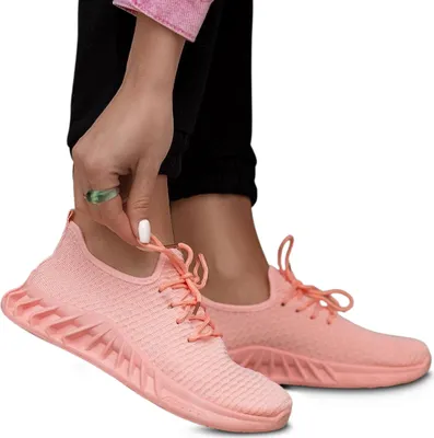 A person is wearing pink sneakers.