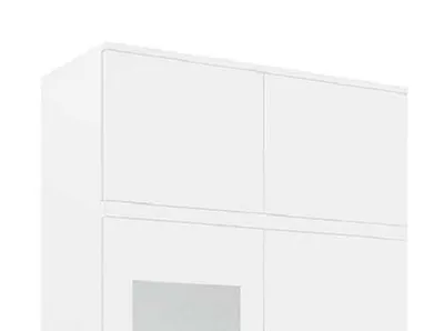 A close-up view of a white wardrobe set, showing the top section with two doors and a hint of a lower section with a mirrored panel.