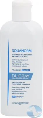 A white bottle of Ducray Squanorm Anti-Dandruff Treatment Shampoo against a white background.