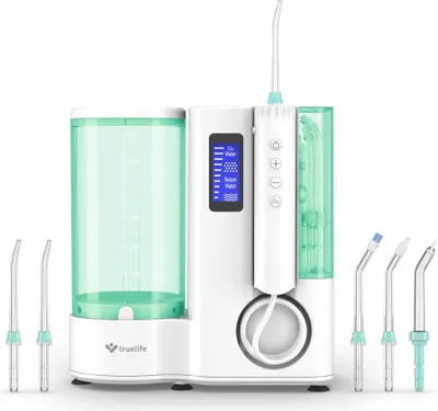 A white and green water flosser with multiple attachments is displayed against a white background.