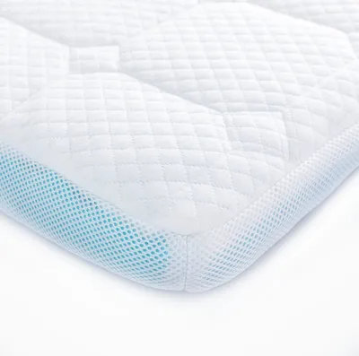 A close-up, angled view of a mattress topper on a white background.