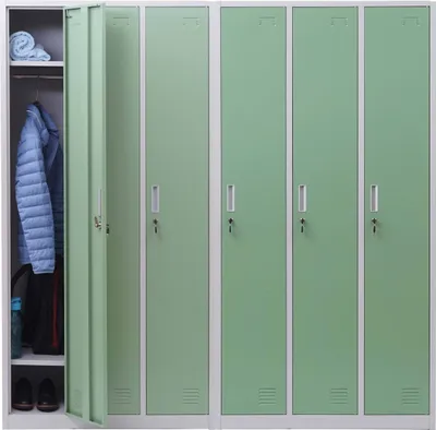 A row of green metal lockers with one door open, revealing clothing and shoes inside.