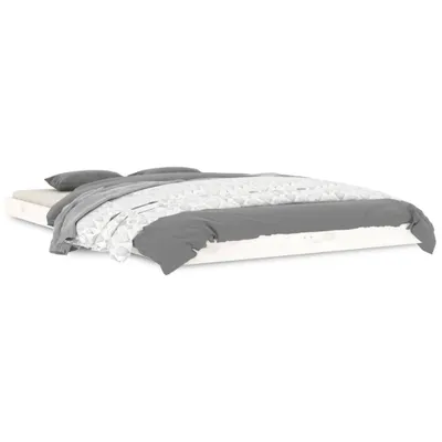 A bed with gray and white bedding on a white background.