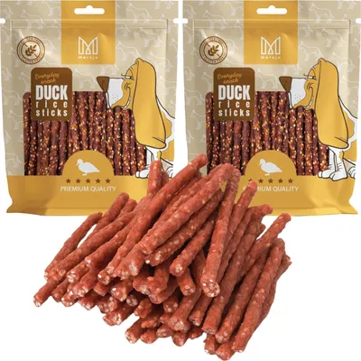 Two bags of dog treats with a pile of treats in front.