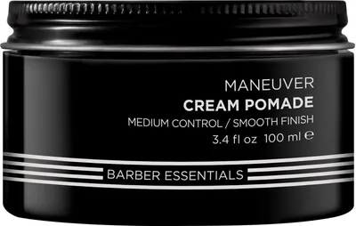 A black jar of hair pomade with white text and stripes.