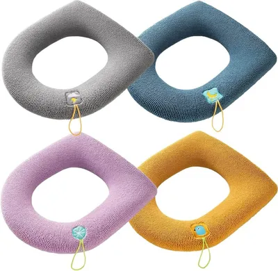 Four toilet seat covers in different colors arranged in a diamond pattern on a white background.