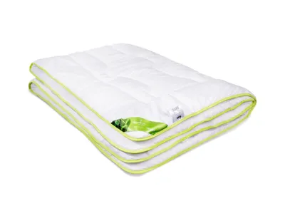 A folded white comforter with a green trim and a green leaf pattern visible on one corner, isolated on a white background.
