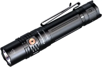 A studio shot of a black and gray flashlight with a copper button, set against a white background.