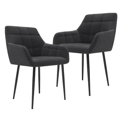 Two dark gray upholstered dining chairs with black metal legs are shown against a white background.