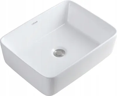 A white ceramic washbasin with a silver drain.