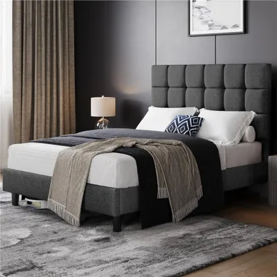 A bedroom scene with a bed, lamp, and curtains.