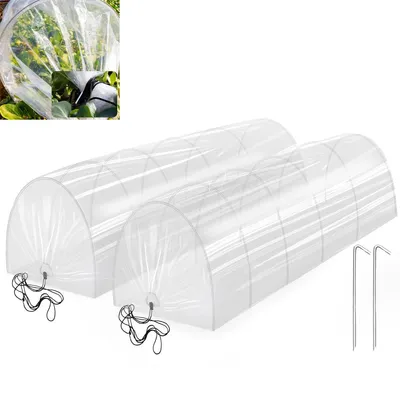 Two clear plastic mini greenhouses in a tunnel shape, with metal stakes.