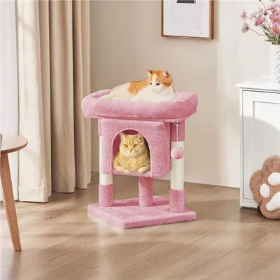 Two cats are relaxing on a pink cat tree in a room with curtains and furniture.