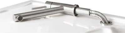 A close-up shot of a modern stainless steel faucet installed in a white sink.