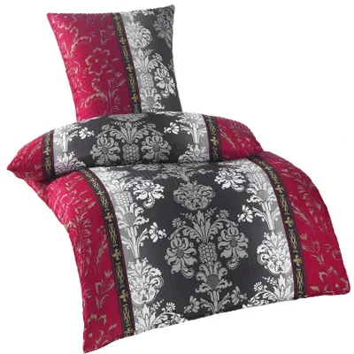 A folded duvet cover and pillowcase set with a damask pattern.