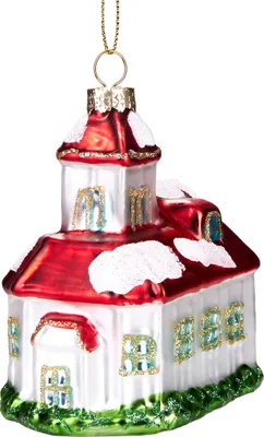 A glass Christmas ornament shaped like a snow-covered church.