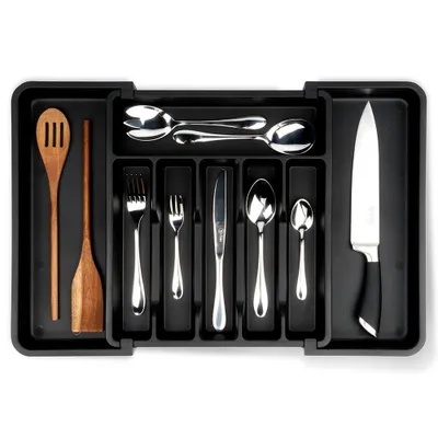 A black cutlery organizer filled with various utensils and a knife, placed on a white background.