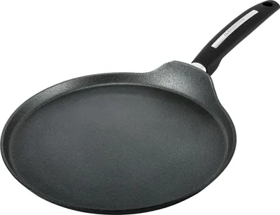 A black crepe pan with a silver and black handle is shown against a white background.