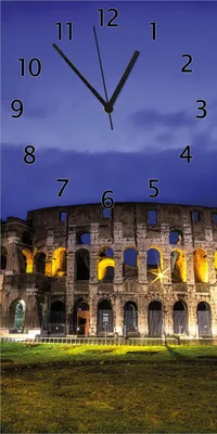 Produktbild von Wallario Design Wanduhr Italien bei Nacht - Kollosseum in Rom, beleuchtet am Abend aus Echtglas, Größe 30 x 60 cm