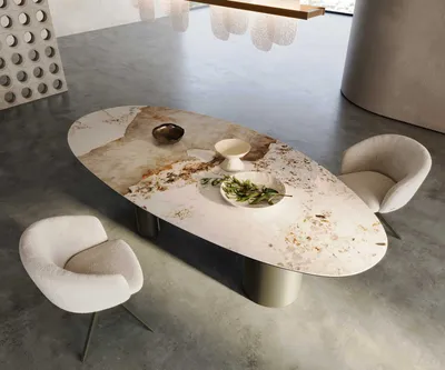 A modern dining room setting with an oval dining table and chairs.