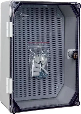 A gray electrical enclosure with a clear door and a bag of hardware inside.