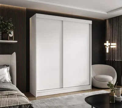 A modern bedroom with a large white sliding door wardrobe.