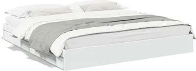 A white bed frame with white and gray bedding.
