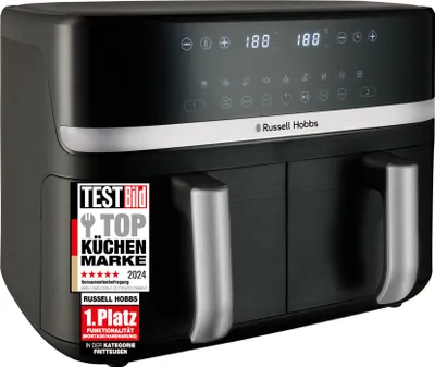 A black Russell Hobbs dual-chamber air fryer is shown against a white background. A promotional sticker is visible on the left side of the product.