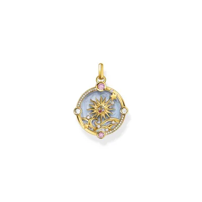 A close-up studio shot of a round, gold-colored pendant with a celestial design.