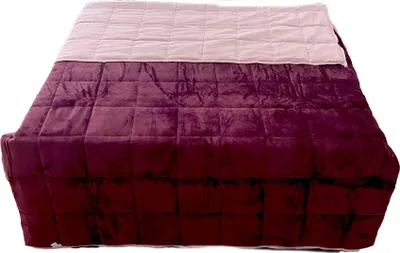 A quilted blanket on a bed.