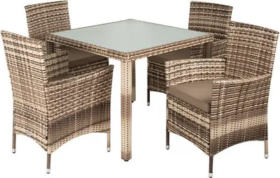 A polyrattan dining set with a glass-topped table and four chairs, presented on a white background.