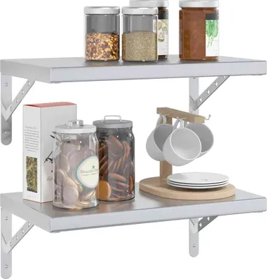 Two stainless steel shelves are shown, one above the other, displaying various kitchen items like jars of spices, cookies, and mugs.