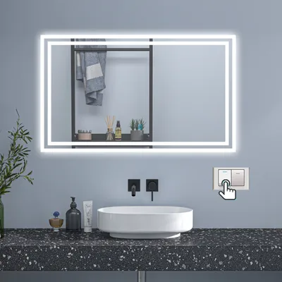 A modern bathroom vanity with a lit mirror, sink, and faucet.