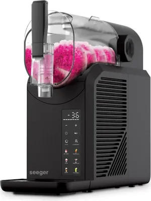 A black slush maker filled with pink slush.