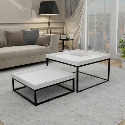 A living room scene with a sofa, floor lamp, and two nesting coffee tables.