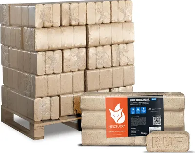 A pallet of compressed wood briquettes for fuel, with a close-up of a package in the foreground.