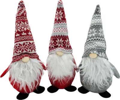 Three Christmas gnomes with knitted hats and white beards are standing against a white background.