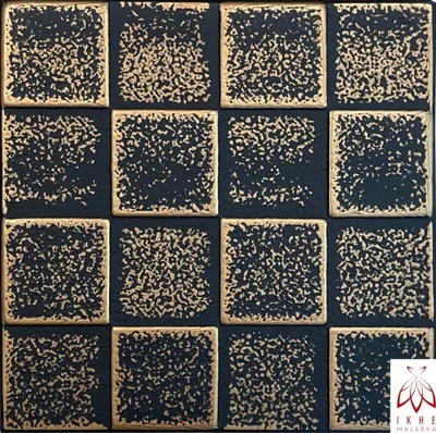 A close-up, repeating pattern of dark squares with textured gold borders, resembling tiles or wall panels.