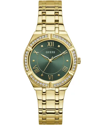 A gold Guess watch with a green dial and crystal accents on a white background.