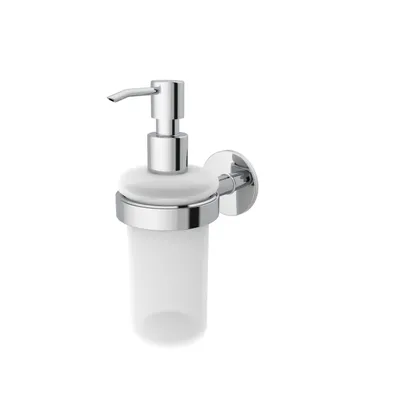 A wall-mounted soap dispenser with a glass container and a chrome pump.