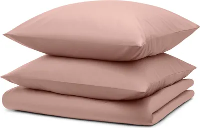 A stack of folded bedding in a light pink color.
