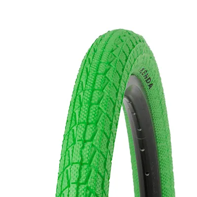 A close-up view of a green bicycle tire with a visible tread pattern and the brand name 'KENDA' printed on the sidewall.