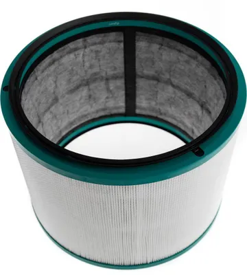 A cylindrical air purifier filter with a teal top and bottom rim and a white pleated filter element.