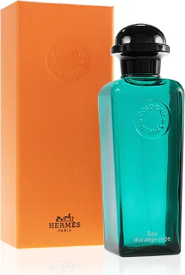 A bottle of Hermès Eau d'Orange Verte cologne and its orange packaging.
